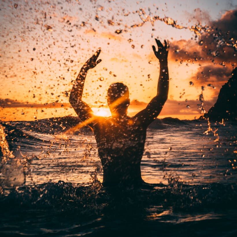 silhouette photography of man at beach during sunset