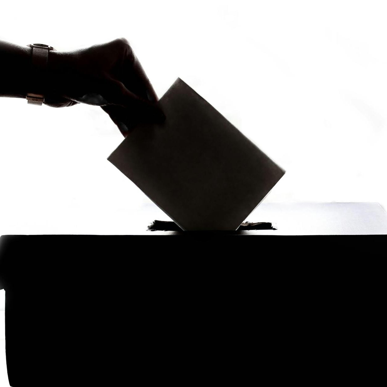 person dropping paper on box
