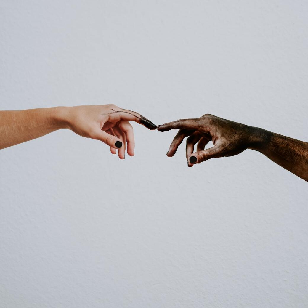 hands of people reaching to each other